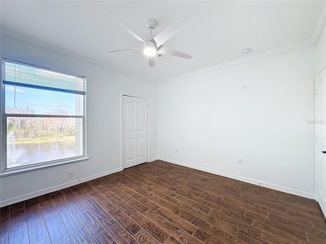 unfurnished room with crown molding, dark hardwood / wood-style floors, and ceiling fan