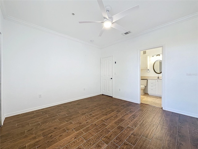 unfurnished bedroom featuring crown molding, dark wood-type flooring, ceiling fan, and ensuite bathroom