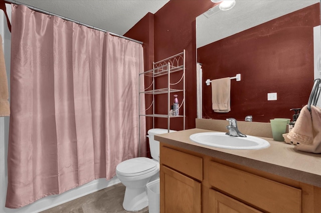 full bathroom featuring vanity, shower / bath combination with curtain, a textured ceiling, and toilet