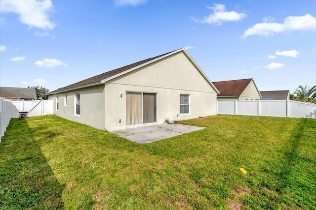 back of house featuring a patio and a lawn