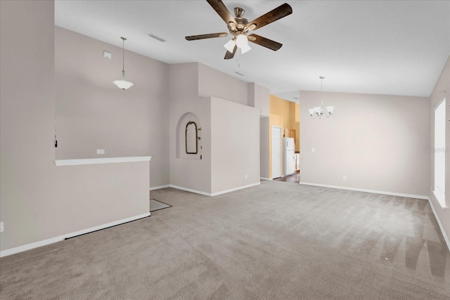 unfurnished living room featuring ceiling fan with notable chandelier, high vaulted ceiling, and carpet floors