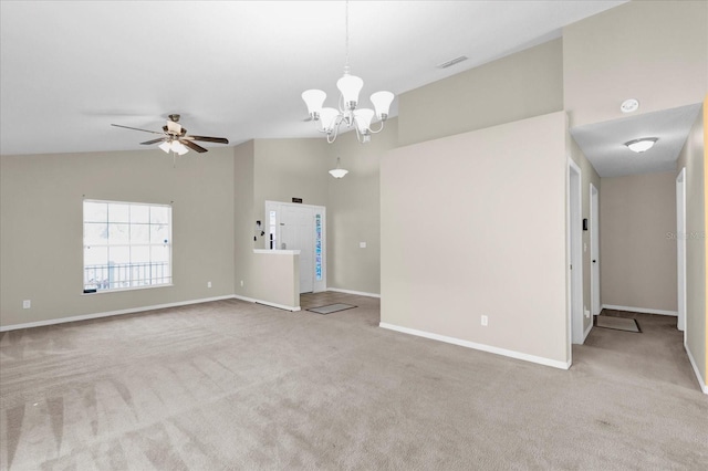 unfurnished living room with lofted ceiling, ceiling fan with notable chandelier, and light colored carpet