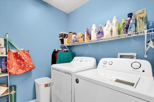 washroom with independent washer and dryer and a textured ceiling