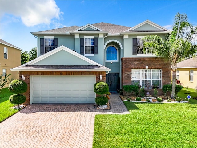 view of front of home featuring a garage and a front lawn