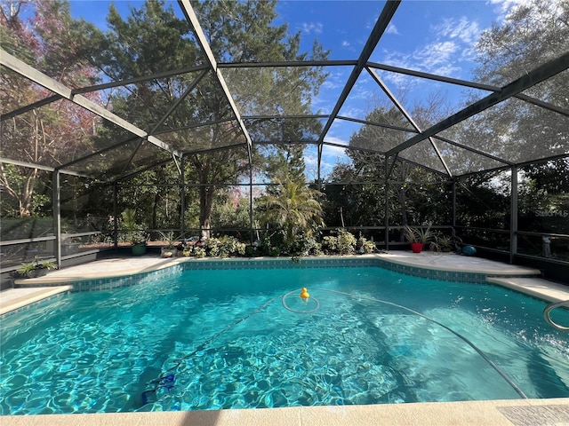 view of swimming pool with glass enclosure