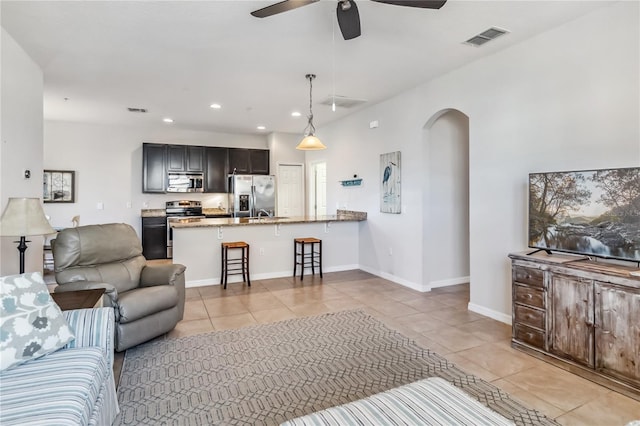 living room with light tile patterned floors and ceiling fan