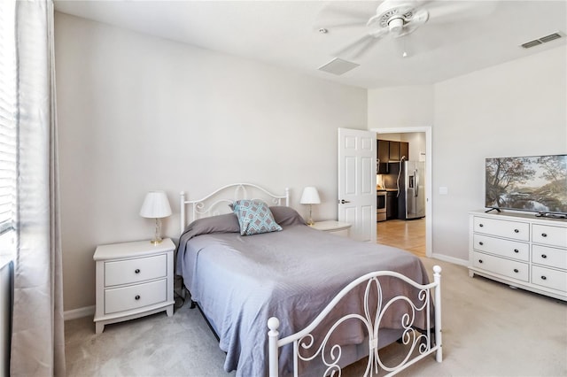 carpeted bedroom with stainless steel fridge with ice dispenser and ceiling fan