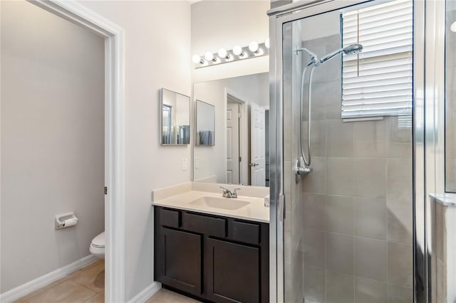 bathroom featuring tile patterned flooring, vanity, an enclosed shower, and toilet