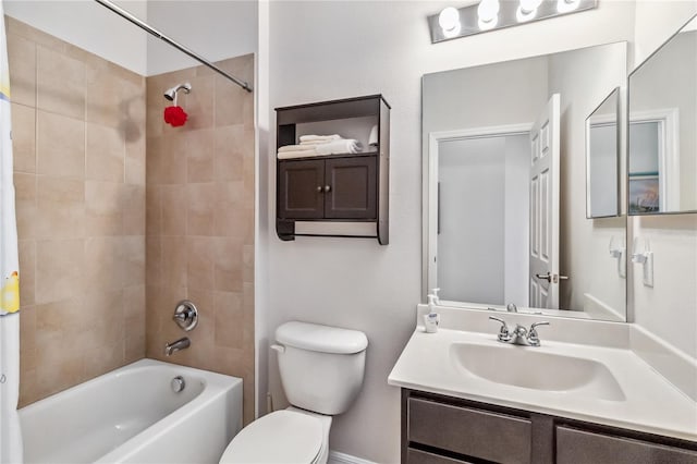 full bathroom featuring tiled shower / bath combo, vanity, and toilet