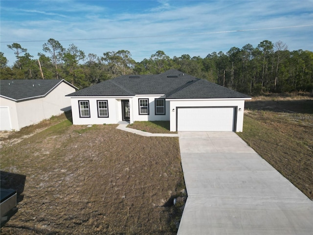 ranch-style house with a garage and a front yard