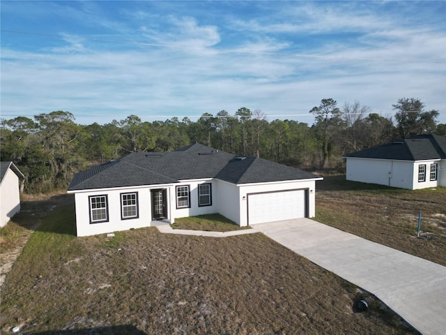 ranch-style home with a garage and a front yard