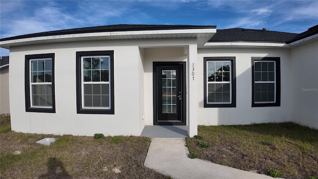 doorway to property with a yard