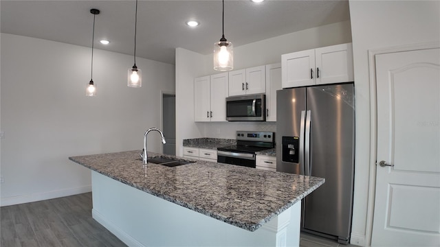 kitchen with white cabinetry, an island with sink, stainless steel appliances, and sink