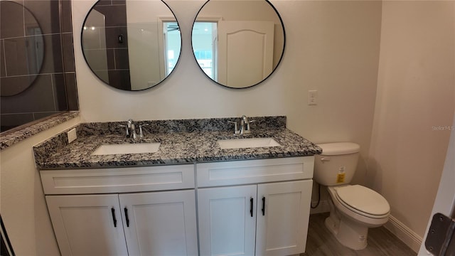 bathroom featuring vanity, hardwood / wood-style floors, and toilet