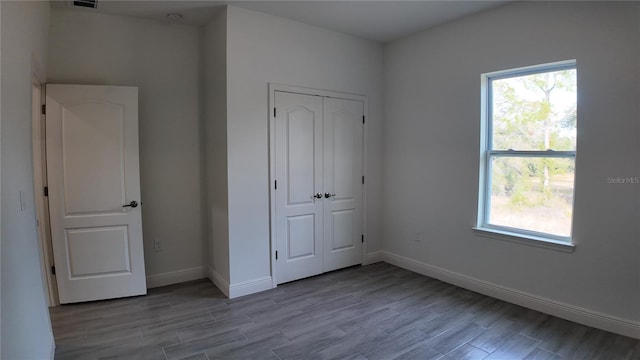 unfurnished bedroom featuring light hardwood / wood-style floors and a closet