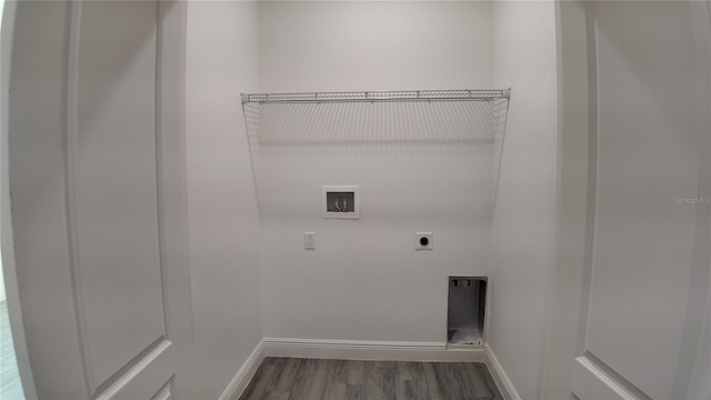 clothes washing area with hookup for a washing machine, hardwood / wood-style floors, and electric dryer hookup