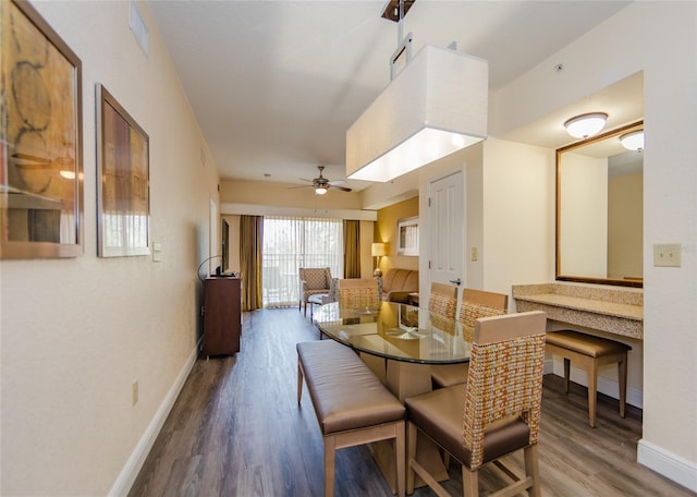 dining room with wood-type flooring and ceiling fan