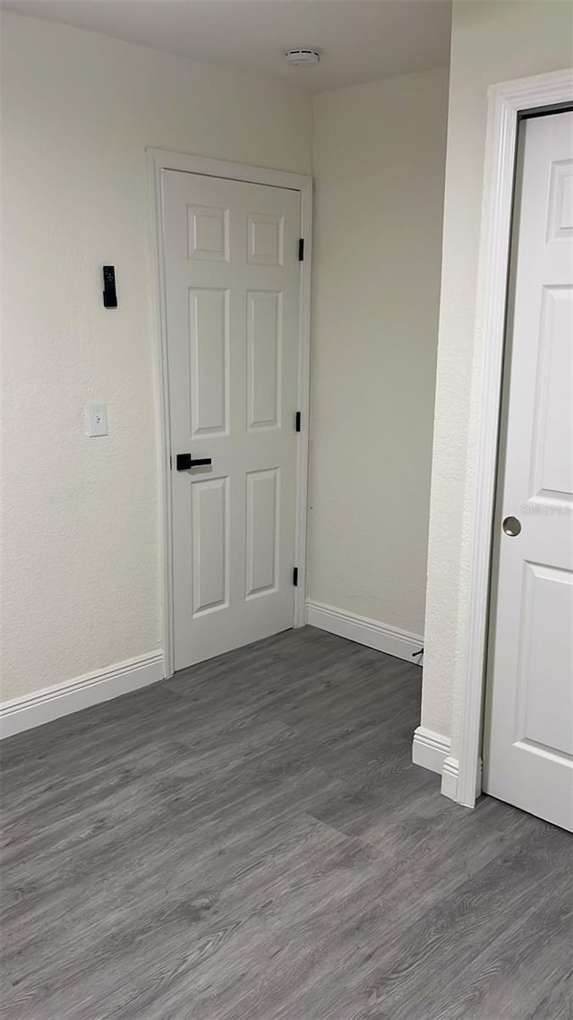 spare room with dark hardwood / wood-style floors