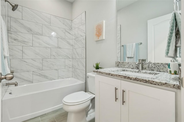 full bathroom with vanity, toilet, and tiled shower / bath