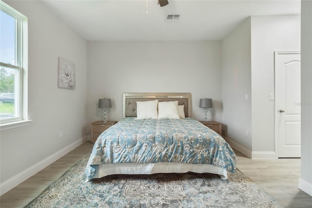 bedroom with light hardwood / wood-style flooring and ceiling fan