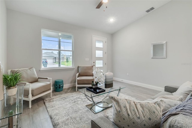 living room featuring wood-type flooring, lofted ceiling, and ceiling fan