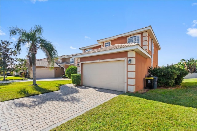 view of front of property featuring a garage and a front lawn