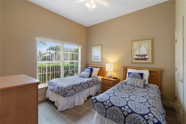 tiled bedroom featuring ceiling fan