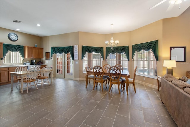 tiled dining room with a chandelier