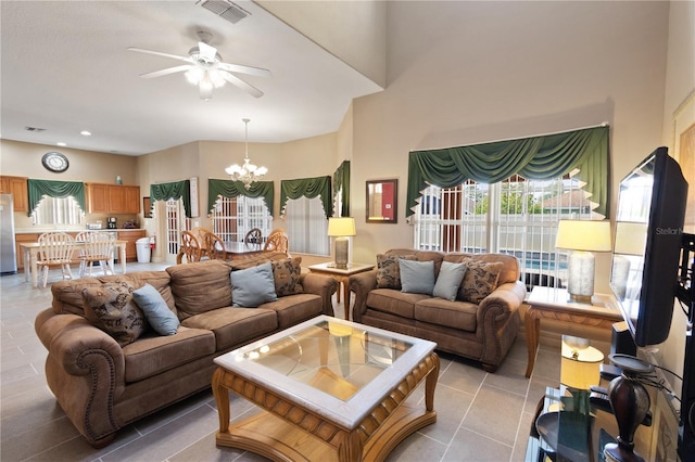 living room featuring light tile patterned flooring and ceiling fan with notable chandelier