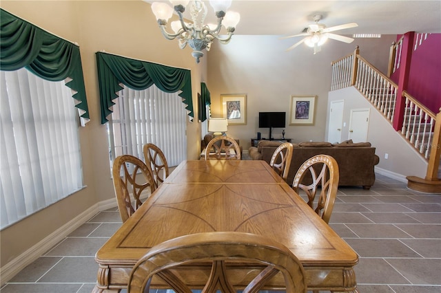 tiled dining area with ceiling fan with notable chandelier