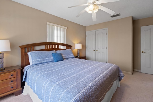 bedroom with light carpet, ceiling fan, and a closet