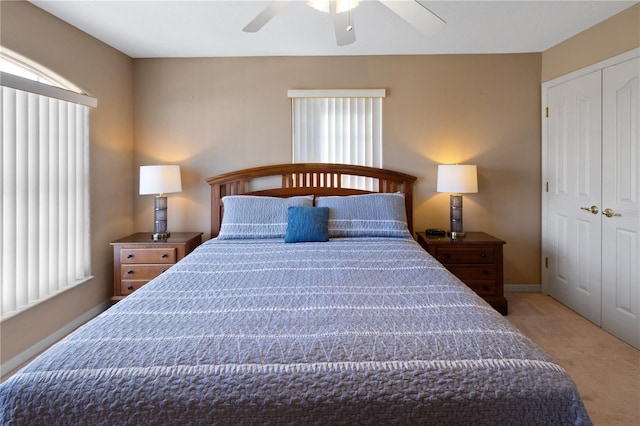 carpeted bedroom featuring a closet and ceiling fan