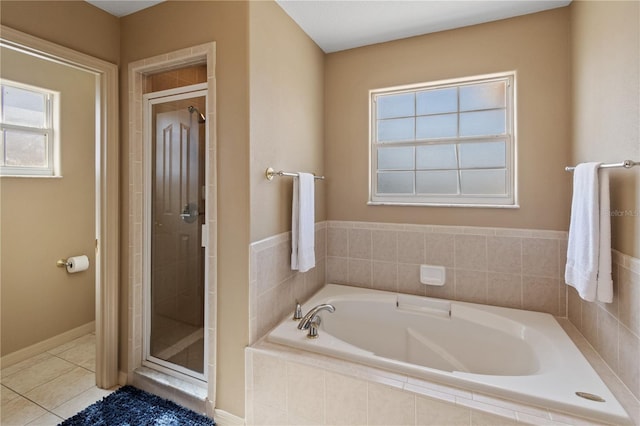 bathroom with plenty of natural light, tile patterned floors, and plus walk in shower