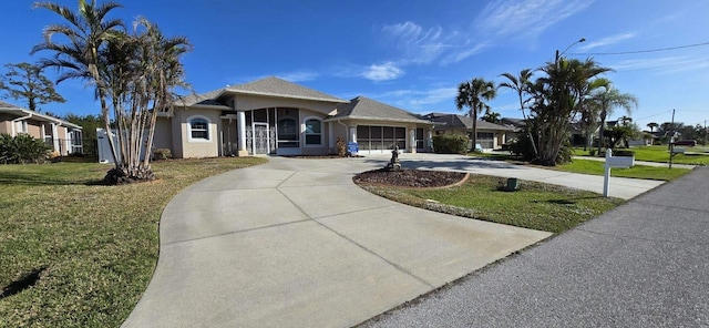 view of front facade with a garage and a front lawn