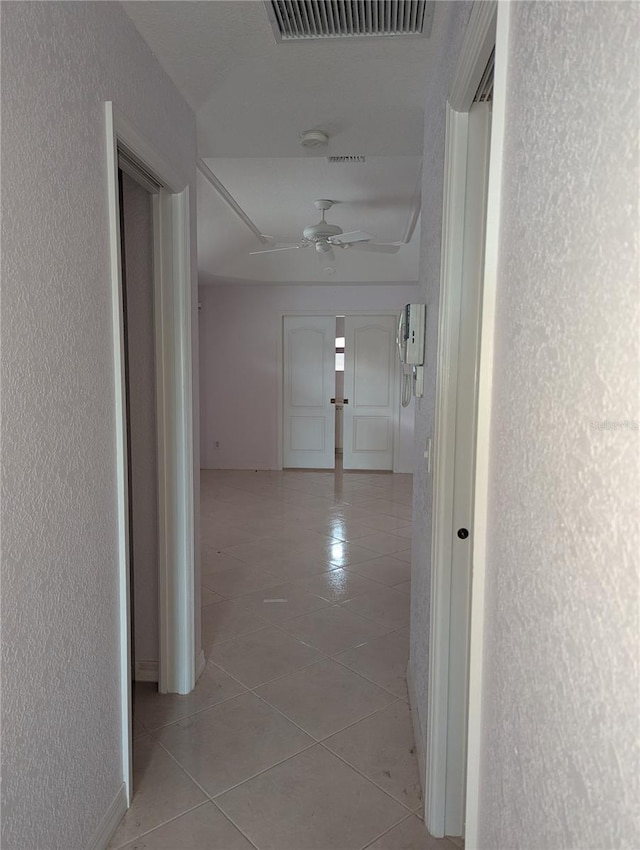 hall with light tile patterned floors