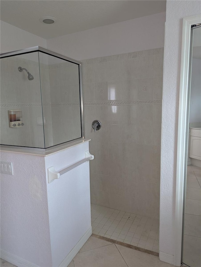 bathroom featuring a tile shower and tile patterned floors