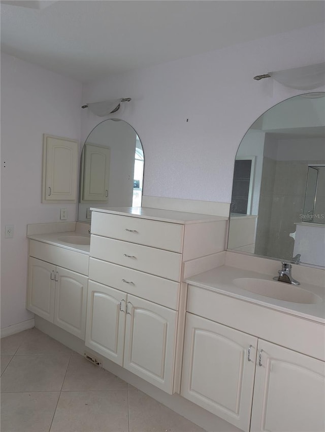 bathroom featuring vanity, tile patterned floors, and a shower