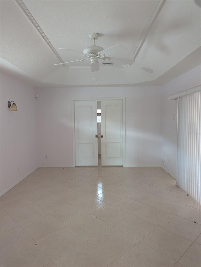 tiled spare room with ceiling fan and a textured ceiling