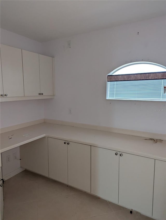 kitchen featuring white cabinetry and light tile patterned floors