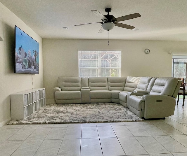 unfurnished living room featuring ceiling fan and light tile patterned flooring