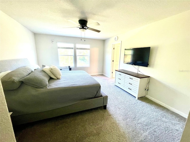 bedroom featuring ceiling fan, carpet, and a textured ceiling