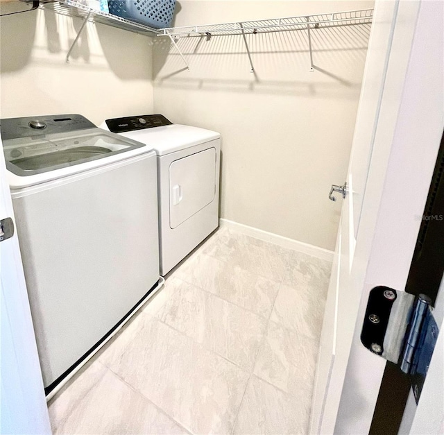 clothes washing area featuring washer and dryer