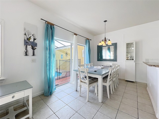 dining space with light tile patterned floors and a chandelier