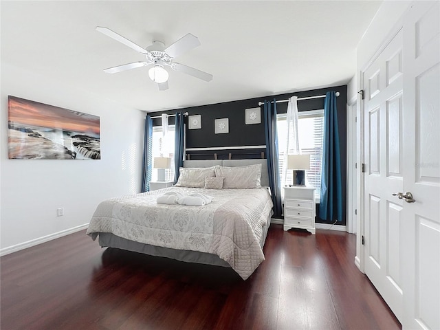 bedroom with ceiling fan and dark hardwood / wood-style flooring