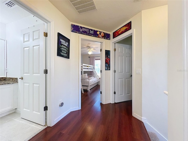 hall with hardwood / wood-style flooring