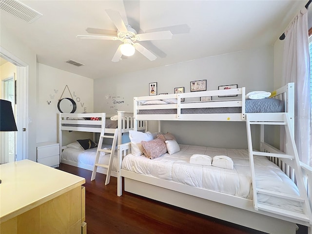 bedroom with dark hardwood / wood-style floors and ceiling fan