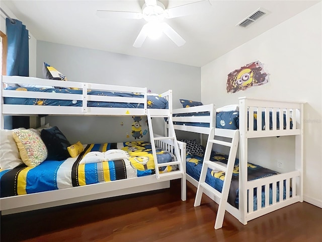 bedroom with dark hardwood / wood-style floors and ceiling fan