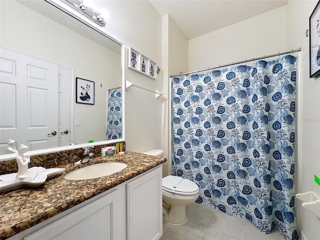 bathroom with vanity, walk in shower, tile patterned floors, and toilet