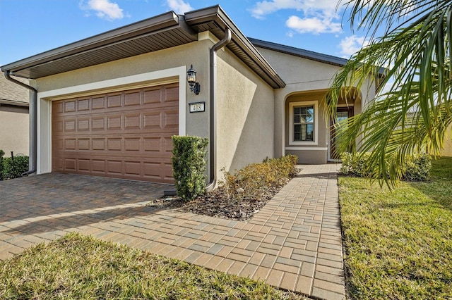 view of front of home with a garage and a front lawn