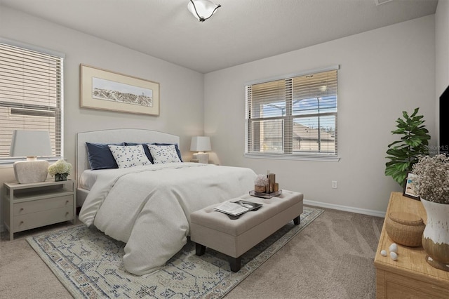 bedroom with baseboards and carpet